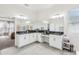 Bright main bathroom featuring a large vanity with dual sinks and ensuite bath access at 3952 Bonfire Dr, Odessa, FL 33556