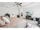 Spacious main bedroom features a tray ceiling, ceiling fan, large bed and mounted TV at 3952 Bonfire Dr, Odessa, FL 33556