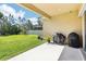 Covered patio with lush green lawn and fence providing privacy and a pleasant outdoor space at 3952 Bonfire Dr, Odessa, FL 33556