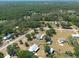 Aerial view showcasing the property's surroundings, featuring trees and homes in the area at 4416 Tevalo Dr, Valrico, FL 33596