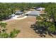 Expansive aerial view of the property featuring a long driveway, a large backyard, and a detached carport at 4416 Tevalo Dr, Valrico, FL 33596