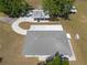 Overhead view of a well-maintained home, featuring large backyard, mature trees, and detached covered parking at 4416 Tevalo Dr, Valrico, FL 33596
