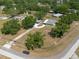 Full aerial view of the home, featuring a circular driveway, detached covered parking, and mature landscaping at 4416 Tevalo Dr, Valrico, FL 33596