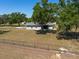Exterior shot of home with a backyard surrounded by a chain link fence, offering privacy and a large lawn area at 4416 Tevalo Dr, Valrico, FL 33596