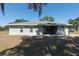 Backyard view of home featuring siding, windows, and a well-manicured lawn at 4416 Tevalo Dr, Valrico, FL 33596