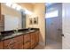 Bathroom with double vanity, wood cabinets and glass shower at 4416 Tevalo Dr, Valrico, FL 33596