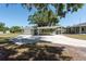 The home's exterior features a detached garage, covered parking and a concrete driveway at 4416 Tevalo Dr, Valrico, FL 33596
