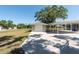 Exterior view of the detached garage with a white door and a covered parking area next to it at 4416 Tevalo Dr, Valrico, FL 33596