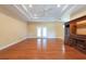 Open-concept living room boasts hardwood floors, tray ceiling, and a built-in fireplace at 4416 Tevalo Dr, Valrico, FL 33596