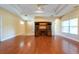 Spacious living room with hardwood floors, ceiling fan, and built-in entertainment center at 4416 Tevalo Dr, Valrico, FL 33596