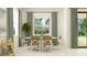 Bright dining room featuring an oval table, seating for six, and a stylish bar cart for entertaining at 4470 Southern Valley Loop, Brooksville, FL 34601