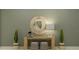 Stylish entryway featuring a round mirror, decorative table, stools, and plants at 4470 Southern Valley Loop, Brooksville, FL 34601