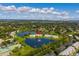 Aerial shot of waterfront townhomes with a community pool, tennis courts, and lake views at 4816 Snook Se Dr # F, St Petersburg, FL 33705