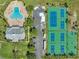 Stunning aerial view of the community pool, tennis courts, and clubhouse amenities at 4816 Snook Se Dr # F, St Petersburg, FL 33705