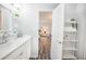 Bathroom featuring modern fixtures, shelving for storage, and a peek into the bedroom at 4816 Snook Se Dr # F, St Petersburg, FL 33705