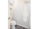 Toilet area featuring modern fixtures and laminate flooring, with shelving for storage at 4816 Snook Se Dr # F, St Petersburg, FL 33705