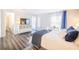 Comfortable bedroom featuring contemporary decor, wood floors, and bright ambiance at 4816 Snook Se Dr # F, St Petersburg, FL 33705
