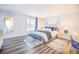 Comfortable bedroom featuring a large bed, modern furniture and decor and wood flooring at 4816 Snook Se Dr # F, St Petersburg, FL 33705