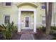 Charming townhome entrance featuring well-manicured landscaping, pathway and covered doorway at 4816 Snook Se Dr # F, St Petersburg, FL 33705
