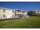 Back exterior of the townhome features an outdoor seating area and staircase leading to a balcony at 4816 Snook Se Dr # F, St Petersburg, FL 33705