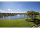 Scenic lake view featuring a fountain, lush landscaping, and clear blue skies at 4816 Snook Se Dr # F, St Petersburg, FL 33705