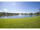 Scenic view of a tranquil pond with a fountain and lush green surroundings at 4816 Snook Se Dr # F, St Petersburg, FL 33705
