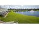 Scenic view of a pond with a fountain, surrounded by lush green lawns and waterfront townhomes at 4816 Snook Se Dr # F, St Petersburg, FL 33705