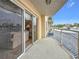 Cozy balcony with sliding glass doors offering a glimpse of the interior, and parking area view at 4900 Brittany S Dr # 211, St Petersburg, FL 33715