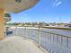Balcony view overlooking the parking area with distant views of buildings and blue skies at 4900 Brittany S Dr # 211, St Petersburg, FL 33715