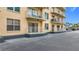 Balcony view showcasing building details with railings and multiple balconies with parking area view at 4900 Brittany S Dr # 211, St Petersburg, FL 33715