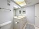 Well-lit bathroom with a white vanity, a spacious mirror, and neutral-toned tiles, creating a calming and modern space at 4900 Brittany S Dr # 211, St Petersburg, FL 33715
