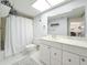 Well-lit bathroom featuring a single sink vanity, commode, and shower/tub combination at 4900 Brittany S Dr # 211, St Petersburg, FL 33715