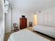 Inviting bedroom showcasing two twin beds, dresser, and wicker chairs offering comfort at 4900 Brittany S Dr # 211, St Petersburg, FL 33715