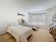 Bright bedroom featuring two twin beds, neutral carpet, and a window with blinds for privacy at 4900 Brittany S Dr # 211, St Petersburg, FL 33715