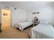 Bedroom with two twin beds, white walls, and closet creating a cozy and functional space at 4900 Brittany S Dr # 211, St Petersburg, FL 33715