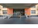 Building entrance featuring accessibility ramp, covered entry, and glass doors at 4900 Brittany S Dr # 211, St Petersburg, FL 33715