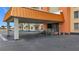 Building entrance with a covered walkway, accessibility ramp, and well-maintained exterior at 4900 Brittany S Dr # 211, St Petersburg, FL 33715