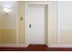 Hallway entrance features a solid white door, plush carpeting, and decorative wall trim at 4900 Brittany S Dr # 211, St Petersburg, FL 33715