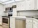 Updated kitchen featuring stainless steel appliances and white cabinetry at 4900 Brittany S Dr # 211, St Petersburg, FL 33715