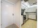 Modern kitchen showcasing sleek stainless steel appliances, white cabinetry, and tile floors at 4900 Brittany S Dr # 211, St Petersburg, FL 33715