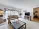 Living room with comfortable seating, TV, and slider to the outdoor deck at 4900 Brittany S Dr # 211, St Petersburg, FL 33715