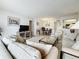 Bright living room featuring neutral decor, comfortable seating, and an open layout connecting to the dining area at 4900 Brittany S Dr # 211, St Petersburg, FL 33715