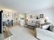 Inviting living room with plush seating, neutral carpet, and a seamless flow to the dining area and kitchen at 4900 Brittany S Dr # 211, St Petersburg, FL 33715