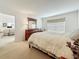 Relaxing bedroom with a soft bed, complemented by natural light from the window and a glimpse into the adjacent living space at 4900 Brittany S Dr # 211, St Petersburg, FL 33715