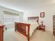 Comfortable bedroom featuring a wooden bed frame, a window with blinds, and a view of the serene outdoor landscape at 4900 Brittany S Dr # 211, St Petersburg, FL 33715