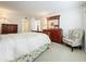 Cozy bedroom with a large bed, wooden dresser, and a comfortable armchair, creating a relaxing retreat at 4900 Brittany S Dr # 211, St Petersburg, FL 33715
