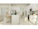 Bright, open kitchen featuring white cabinets, stainless steel appliances, and a breakfast bar at 4923 Southern Valley Loop, Brooksville, FL 34601