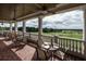 Outdoor patio with dining sets overlooking a scenic golf course view and blue sky at 4923 Southern Valley Loop, Brooksville, FL 34601