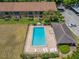 Aerial view featuring the community pool, lounge chairs, and condo parking area at 4991 Puritan Cir # 522, Tampa, FL 33617