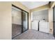 Enclosed tiled balcony features in-unit laundry hookups and sliding glass doors leading inside at 4991 Puritan Cir # 522, Tampa, FL 33617